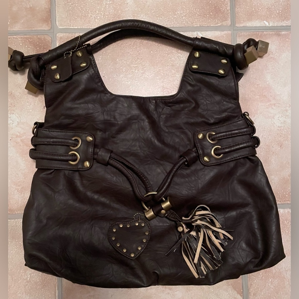 Brown leather tote bag with gold accents, tassel front and heart adornment